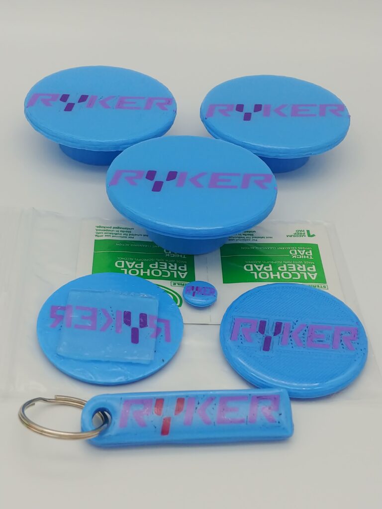 light blue PLA+ Ryker wheel caps set with emblem replacements and keychain